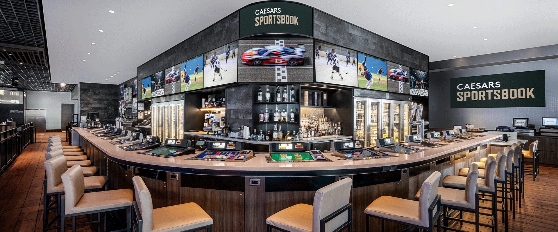 The main bar and wraparound screen wall at Caesars Sportsbook
